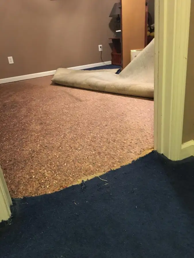 Carpet pad removal revealing water damage during Drying & Dehumidification in Winterset