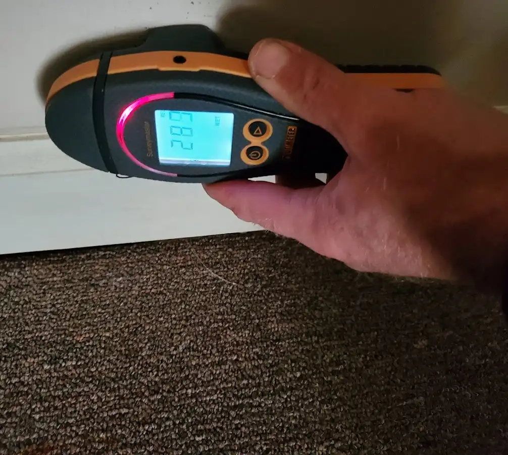 Moisture detection at baseboard during Storm Damage Restoration in Winterset